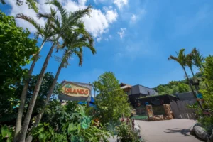 The Islands area of the Pittsburgh Zoo & Aquarium. Featuring the area sign, lush greenery, and the Philippine crocodile exhibit in the background.